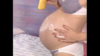 Pregnant Beauty Teases in Heels & Stockings!